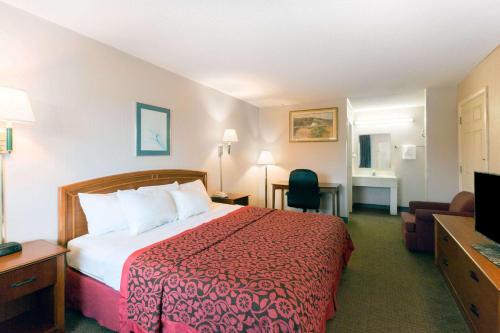 a hotel room with a bed and a television at Days Inn by Wyndham Richmond in Richmond