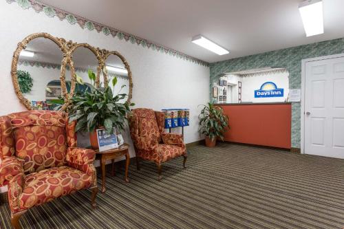 a waiting room at a dental office with chairs and a mirror at Days Inn by Wyndham Dickson in Dickson