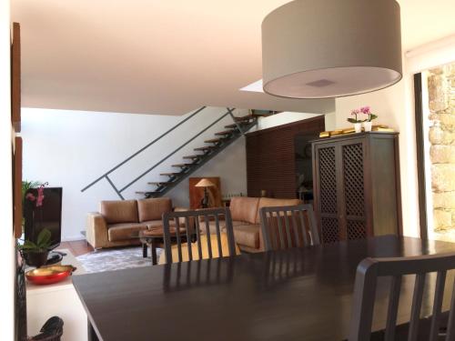 a kitchen and living room with a table and chairs at Liiiving in Caminha | Oak Tree Chill House in Caminha