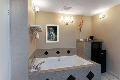 a bathroom with a large tub in a room at Days Inn by Wyndham Alhambra CA in Alhambra