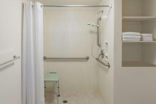 a bathroom with a shower with a shower curtain at Days Inn by Wyndham Camarillo - Ventura in Camarillo