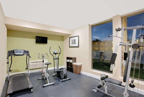 a gym with several tread machines and a window at Days Inn by Wyndham Easton in Easton