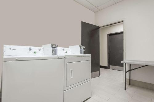 a laundry room with a dishwasher and a sink at Days Inn by Wyndham Ashland in Cannonsburg