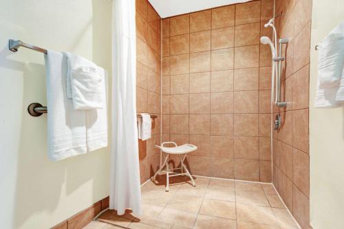 a bathroom with a shower and a toilet at Days Inn by Wyndham Albuquerque West in Albuquerque