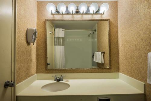 a bathroom with a sink and a mirror at Days Inn by Wyndham Atlantic City Oceanfront-Boardwalk in Atlantic City