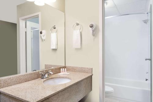 a bathroom with a sink and a shower at Days Inn by Wyndham Windsor Locks / Bradley Intl Airport in Windsor Locks