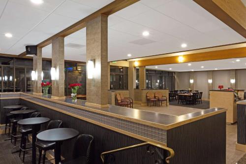 a bar in a restaurant with tables and chairs at Days Inn by Wyndham Lanham Washington DC in Lanham