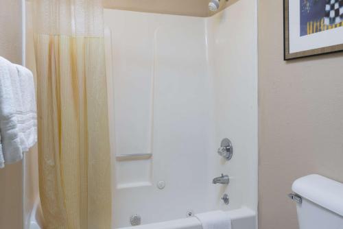 a bathroom with a shower with a shower curtain at Days Inn by Wyndham Pinole Berkeley in Pinole