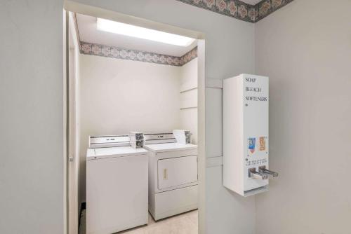 a white kitchen with a stove and a refrigerator at Days Inn by Wyndham Jellico - Tennessee State Line in Jellico