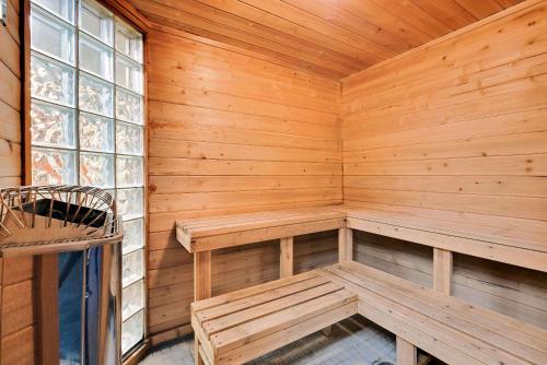 a wooden sauna with benches and a window at Days Inn by Wyndham International Falls in International Falls