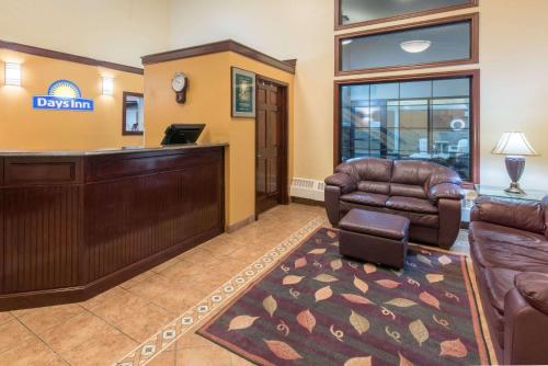 a living room filled with furniture and a fire place at Days Inn by Wyndham Minot in Minot