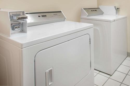 a white washer and dryer in a room at Days Inn by Wyndham Minot in Minot