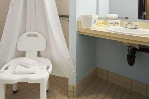 a bathroom with a white toilet and a sink at Days Inn by Wyndham Coeur d'Alene in Coeur d'Alene