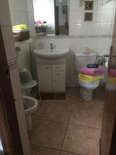 a bathroom with a sink and a toilet and a mirror at Altea, callejeando por su casco antiguo. in Altea