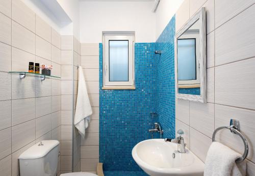 a bathroom with a toilet and a sink at SP villa in Agios Onoufrios
