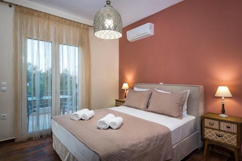 a bedroom with a bed with two towels on it at SP villa in Agios Onoufrios