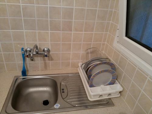 a small bathroom with a sink and a toilet at Cosy apartment Acropolis Point 2 in Athens