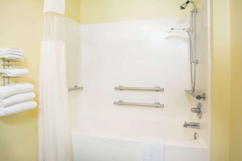 a bathroom with a shower and a bath tub at Days Inn by Wyndham Lexington NE in Lexington