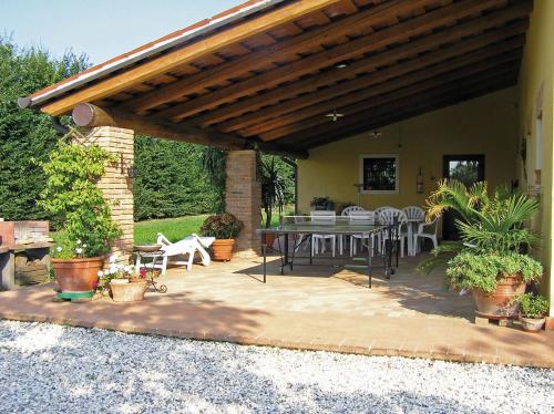 a patio with a table and chairs on it at Fattoria Grimana in Montegalda
