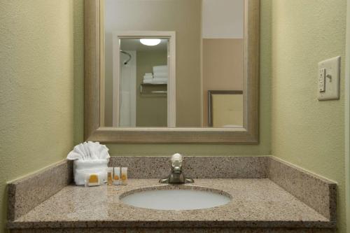 a bathroom with a sink and a mirror at Days Inn by Wyndham Baltimore Inner Harbor in Baltimore