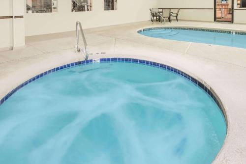 a pool of water with a blue sky at Days Inn by Wyndham Lamar in Lamar