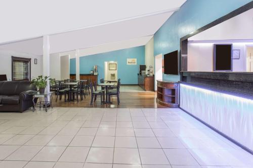 a lobby of a hotel with a dining room at Days Inn by Wyndham Virginia Beach Town Center in Virginia Beach