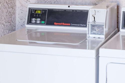a microwave oven sitting on top of a counter at Days Inn by Wyndham Castaic Six Flags Magic Mountain in Castaic