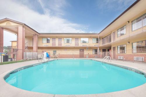 a large swimming pool in front of a building at Days Inn by Wyndham Fayetteville in Fayetteville