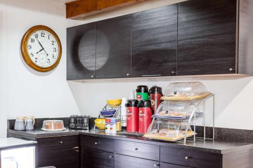 a kitchen counter with a clock on the wall at Days Inn by Wyndham Castaic Six Flags Magic Mountain in Castaic