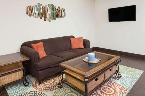 a living room with a couch and a coffee table at Days Inn by Wyndham Charleston in Charleston