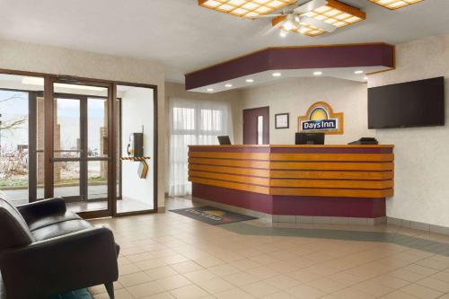 a lobby with a reception desk in a hotel at Days Inn by Wyndham Trois-Rivieres in Trois-Rivières