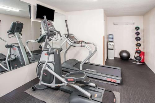 a gym with two tread machines and a treadmill at Days Inn by Wyndham Fort Wayne in Fort Wayne