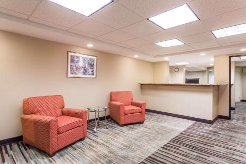 a waiting room with two chairs and a table at Days Inn by Wyndham Dumfries Quantico in Dumfries