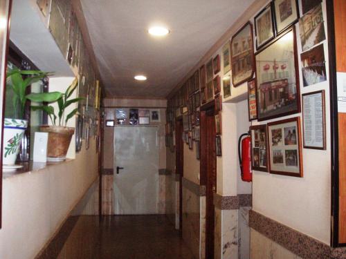 a room that has a bunch of pictures on the wall at Hotel Los Hermanos in Ocaña