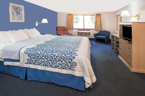 a hotel room with a large bed and a television at Days Inn by Wyndham Corvallis in Corvallis