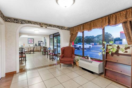 a living room with a large window and a chair at Days Inn by Wyndham Martin in Martin