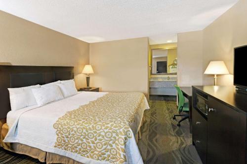 a hotel room with a bed and a television at Days Inn by Wyndham Cherokee Near Casino in Cherokee