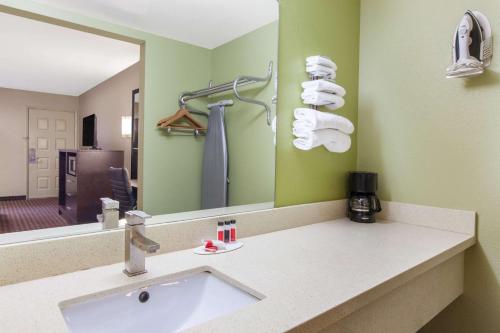 a bathroom with a sink and a mirror at Days Inn by Wyndham San Jose Airport in Milpitas