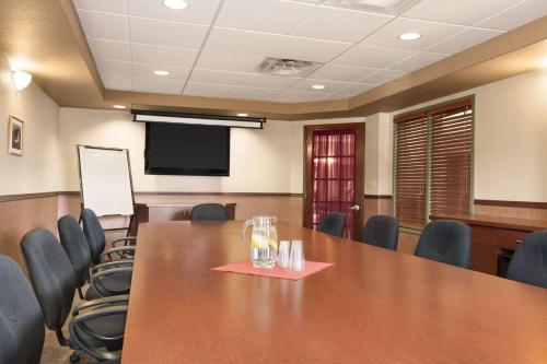 a conference room with a large wooden table and chairs at Days Inn by Wyndham Thunder Bay North in Thunder Bay