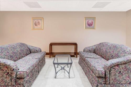 two couches and a table in a waiting room at Days Inn by Wyndham St Augustine/Historic Downtown in Saint Augustine