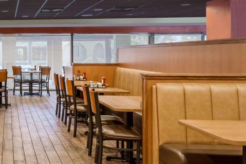 a dining room with wooden tables and chairs at Days Inn by Wyndham St Augustine/Historic Downtown in Saint Augustine