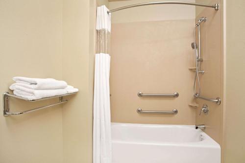 a bathroom with a shower and a white tub at Days Inn by Wyndham Brigham City in Brigham City