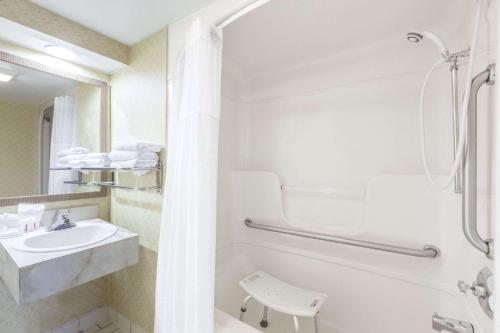 a bathroom with a sink and a shower at Days Inn by Wyndham Utica in Utica