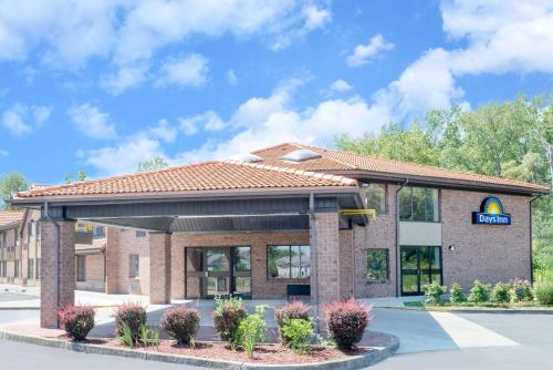 a gas station with a sign in front of it at Days Inn by Wyndham Geneva/Finger Lakes in Geneva