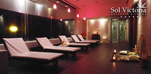 a row of white chairs in a waiting room at Sol Victoria Hotel SPA & Casino in Victoria