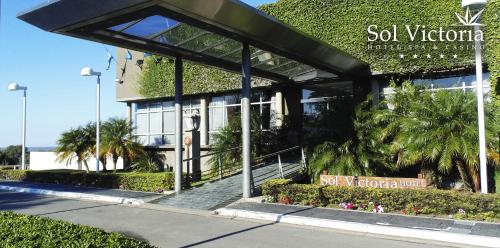 a building with ivy on the side of it at Sol Victoria Hotel SPA & Casino in Victoria
