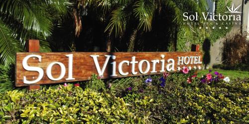 a sign that says so vientoria in front of flowers at Sol Victoria Hotel SPA & Casino in Victoria