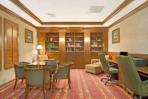 a library with chairs and a table and a couch at Days Inn by Wyndham St. Louis/Westport MO in Maryland Heights