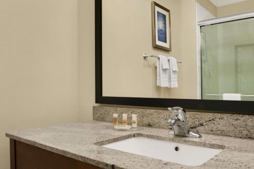 a bathroom with a sink and a mirror at Days Inn by Wyndham Victoria in Victoria