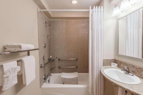 a bathroom with a sink and a tub and a toilet at Days Inn by Wyndham Santa Maria in Santa Maria